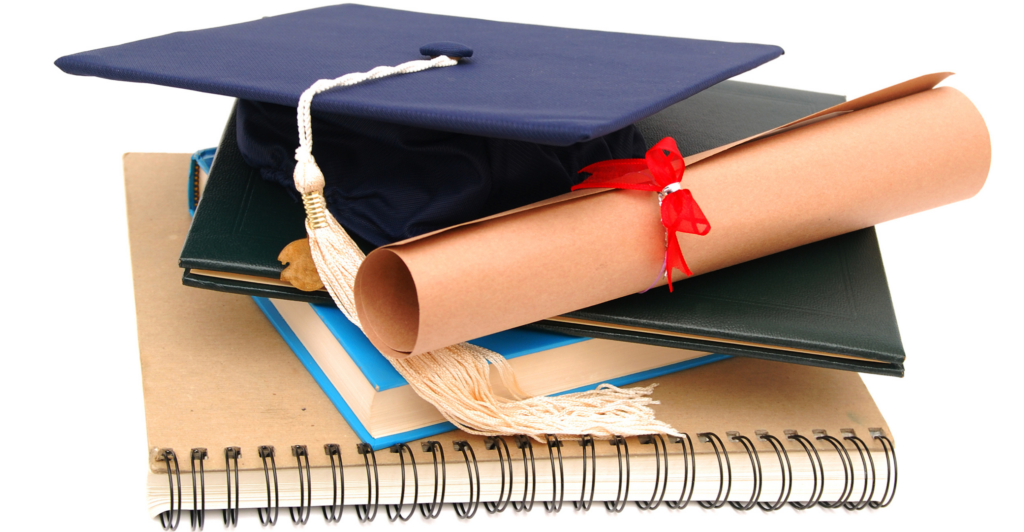 photo of graduation cap and notebooks